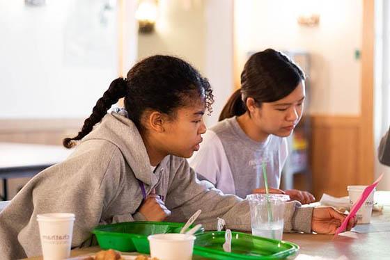 Photo of BIPOC students with food at a table